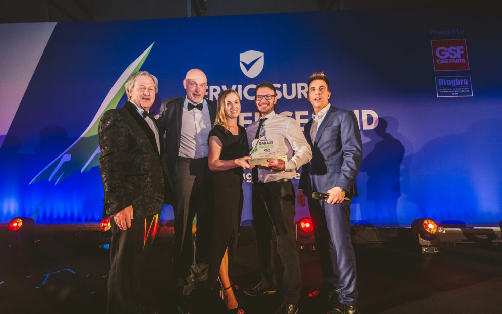 Ashwell Motors Paul and Leanne Garrett awarded Garage of The Year by Steve Horne CEO GSF Håkan Bjellebeck FRAM Sales Director Northern Europe and Russell Kane comedian