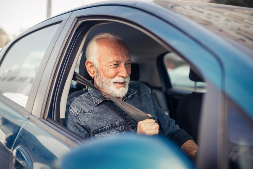 GEM older driver fastens seat belt Shutterstock